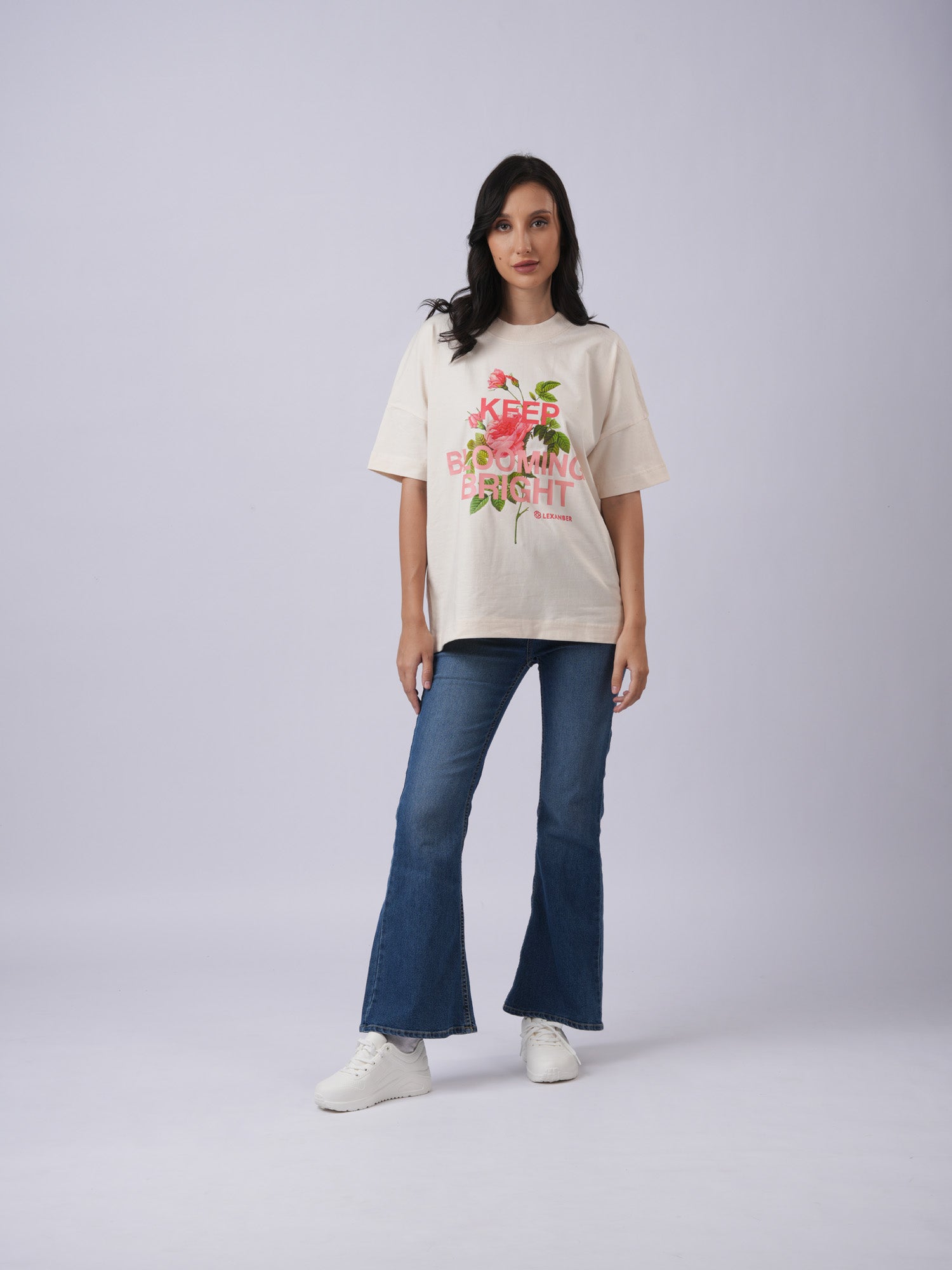 Model wearing oversized  ivory tshirt with floral print  and 'KEEP BLOOMING BRIGHT' - Lexanber UK