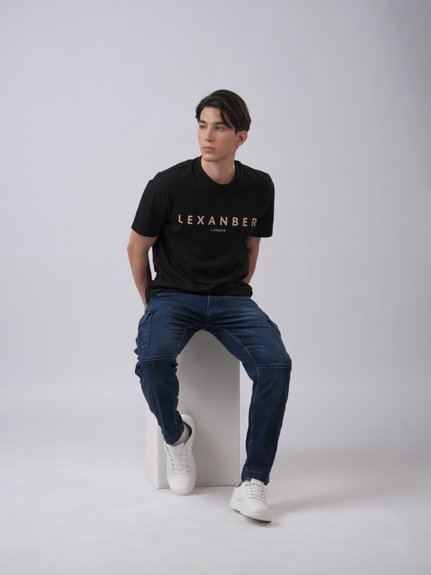 Person wearing a black t-shirt with 'LEXANBER' branding - front view3