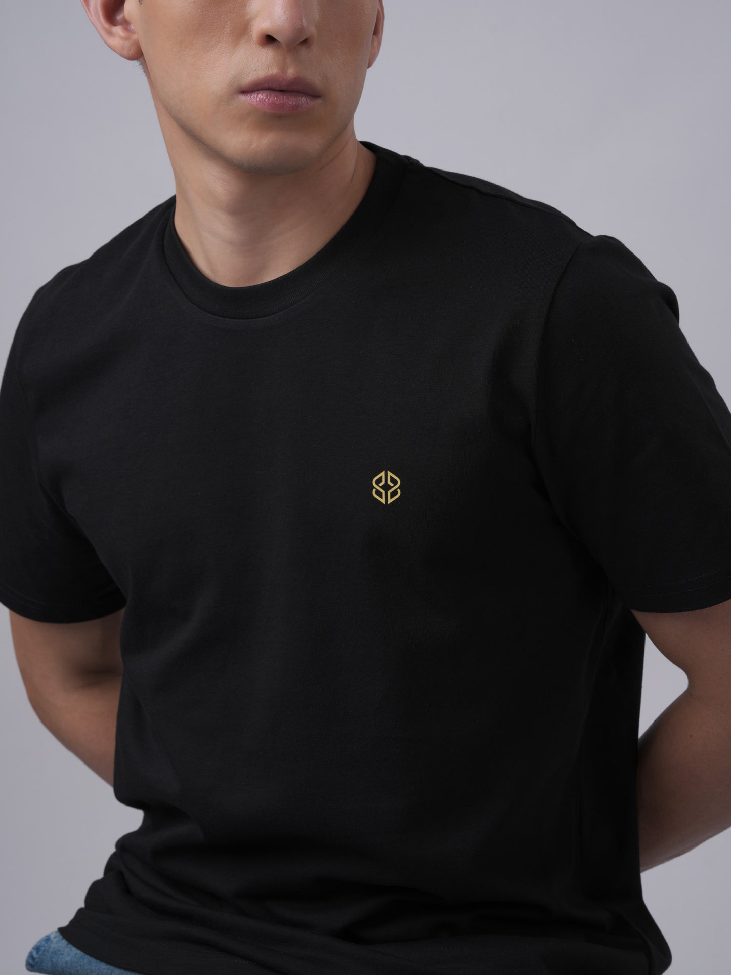 Close-up view of men's organic cotton signature badge black tshirt- Lexanber UK