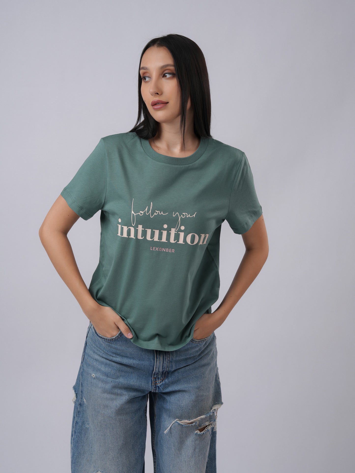 Woman wearing a green t-shirt with 'follow your intuition' text - Lexanber UK