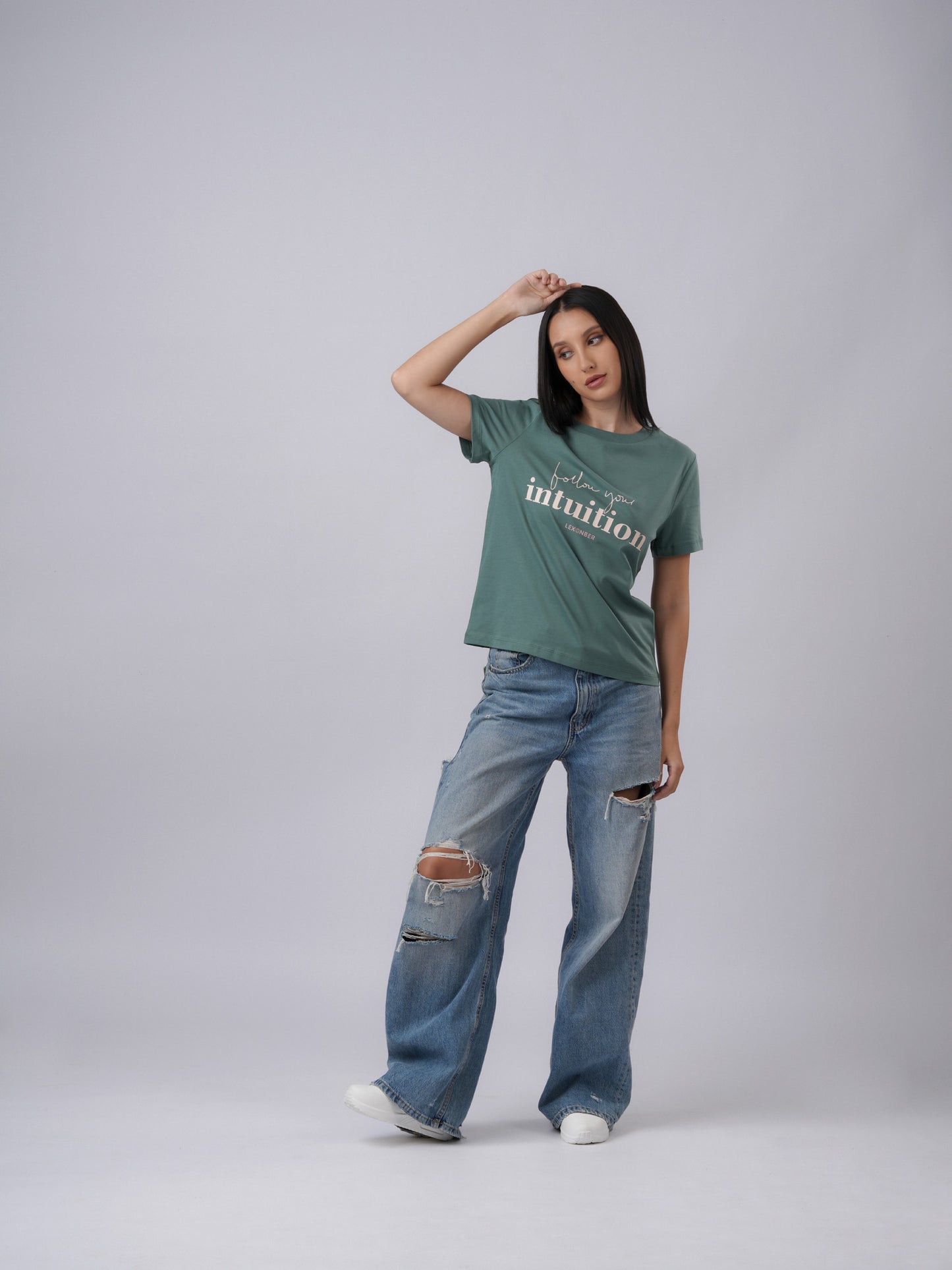 Model wearing organic cotton printed 'Follow Your Intuition' regular eucalyptus green tshirt - Lexanber UK