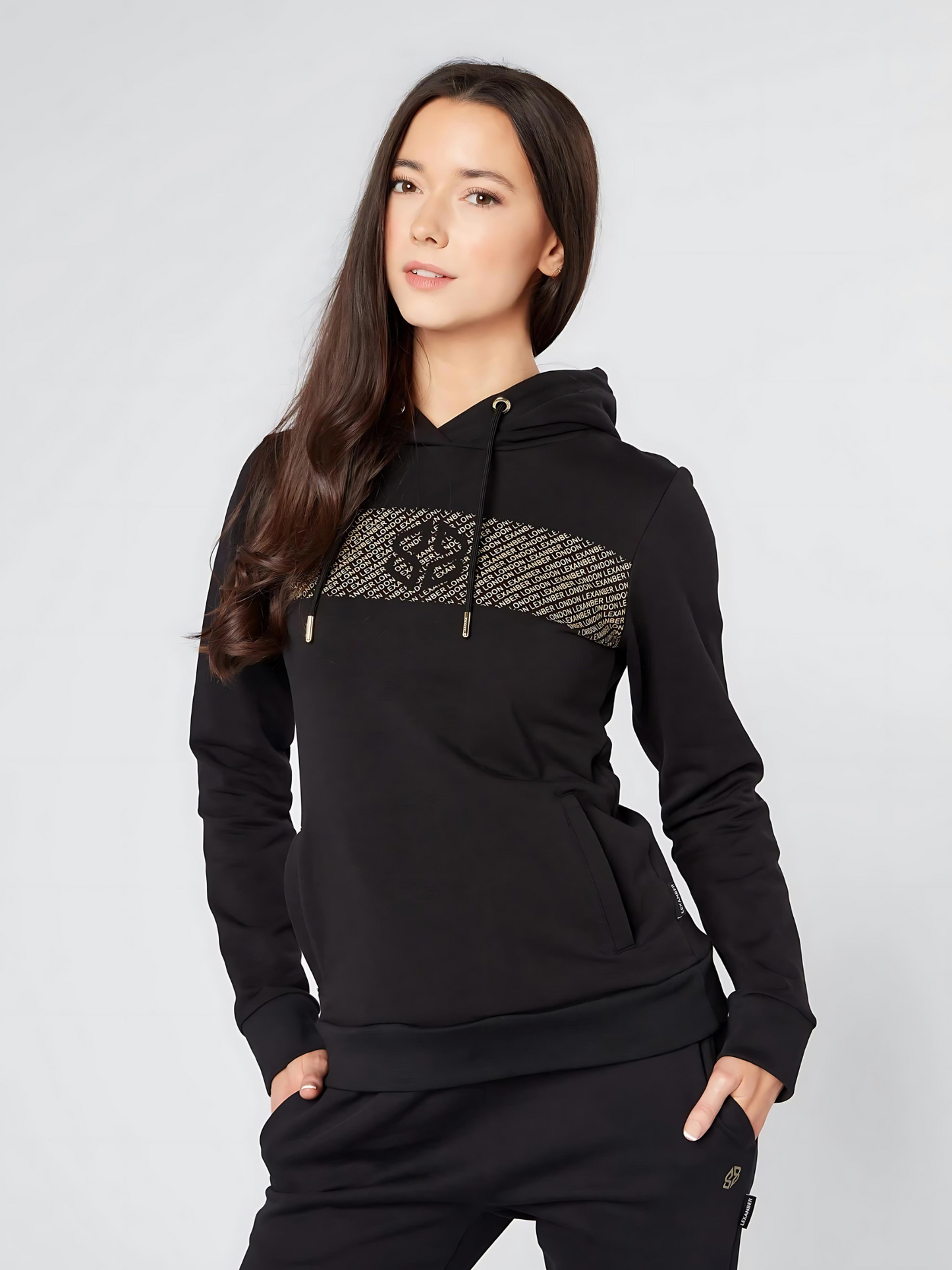 Model wearing LEXANBER women's slim-fit black hoodie with sage green joggers - premium UK streetwear styling