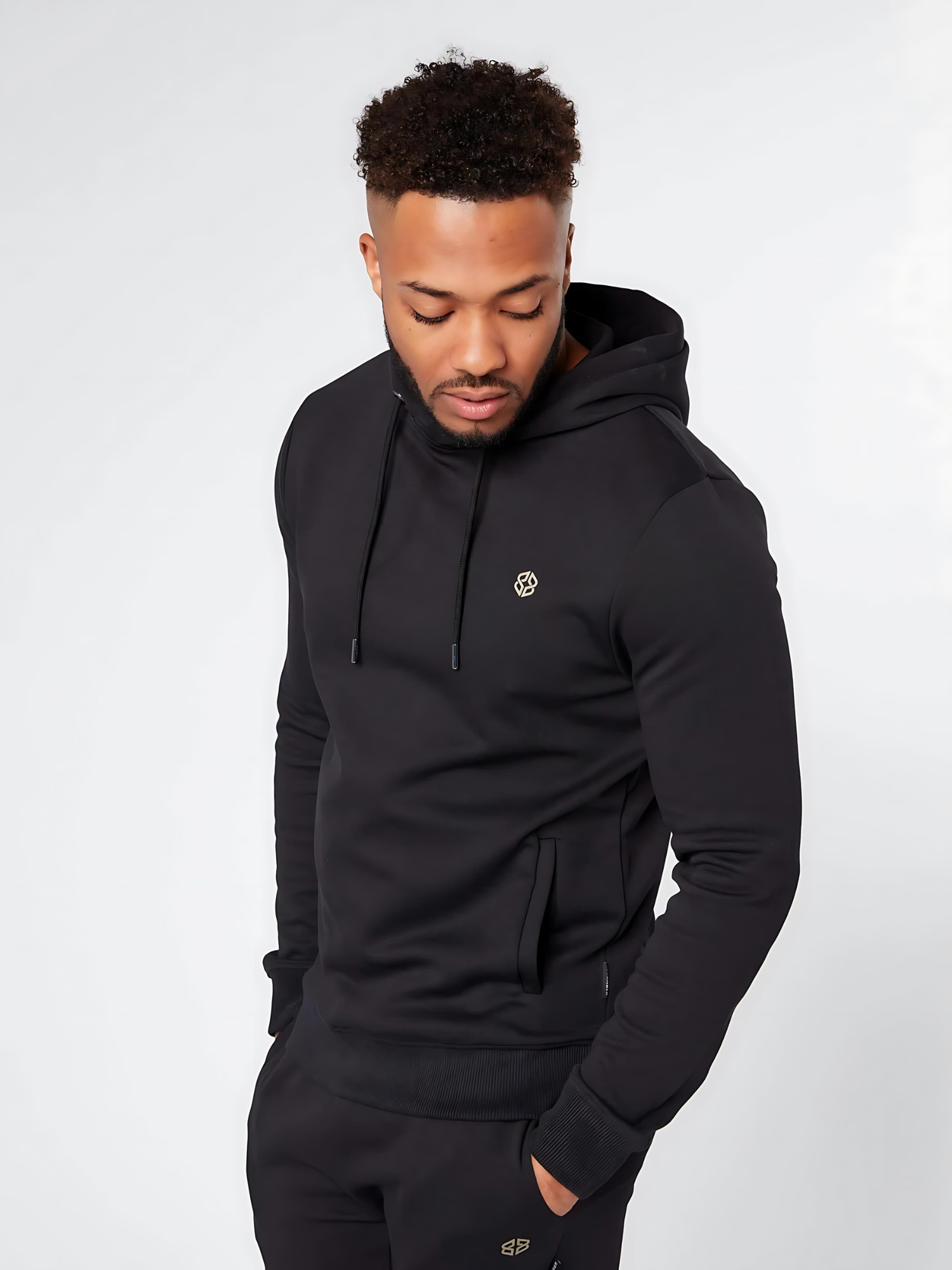 Men's slim fit casual wear overhead hoodie in black with small golden logo - front view - Lexanber UK