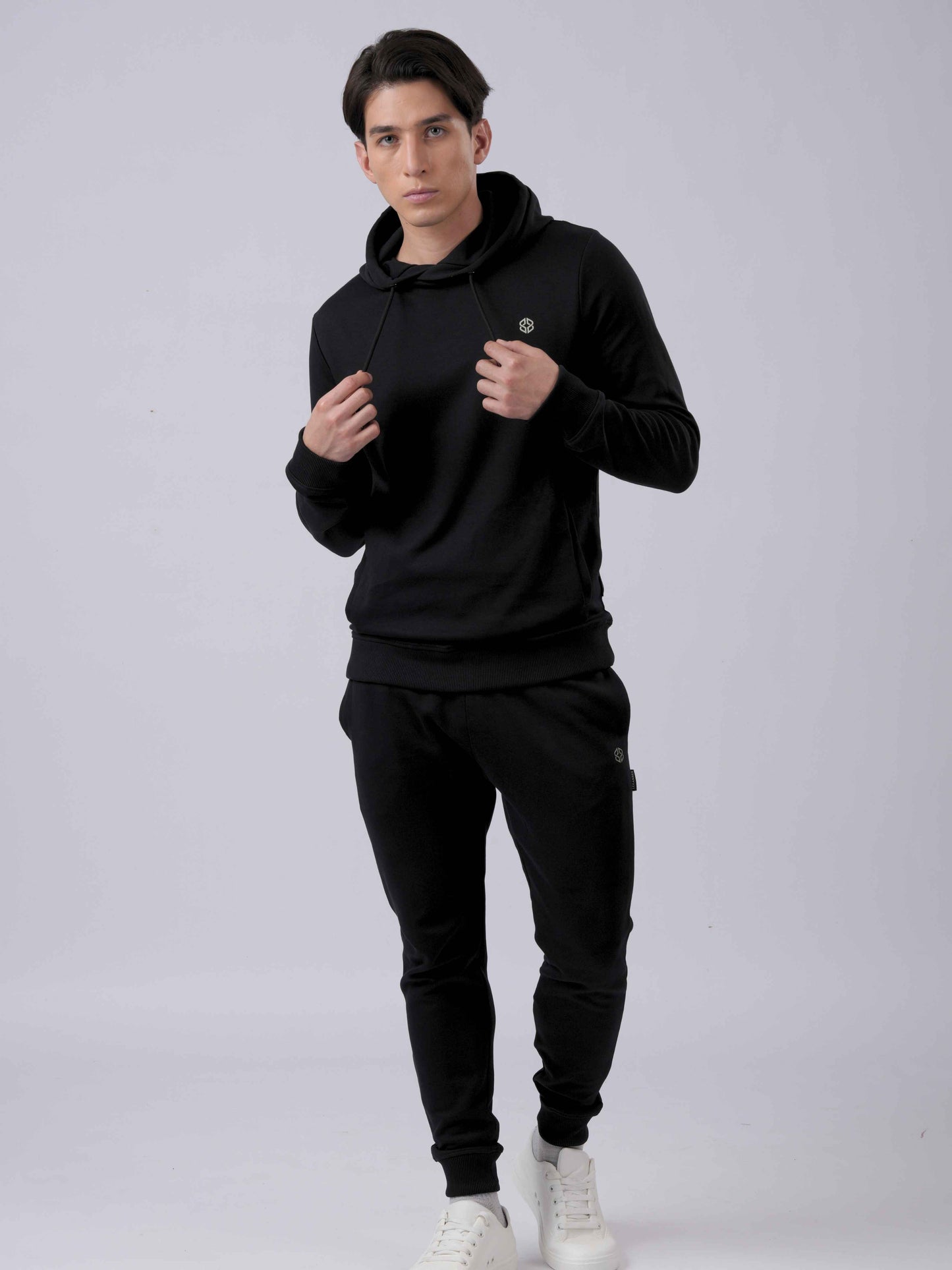 Model wearing LEXANBER men's slim fit black hoodie and jogger with golden logo - Lexanber UK