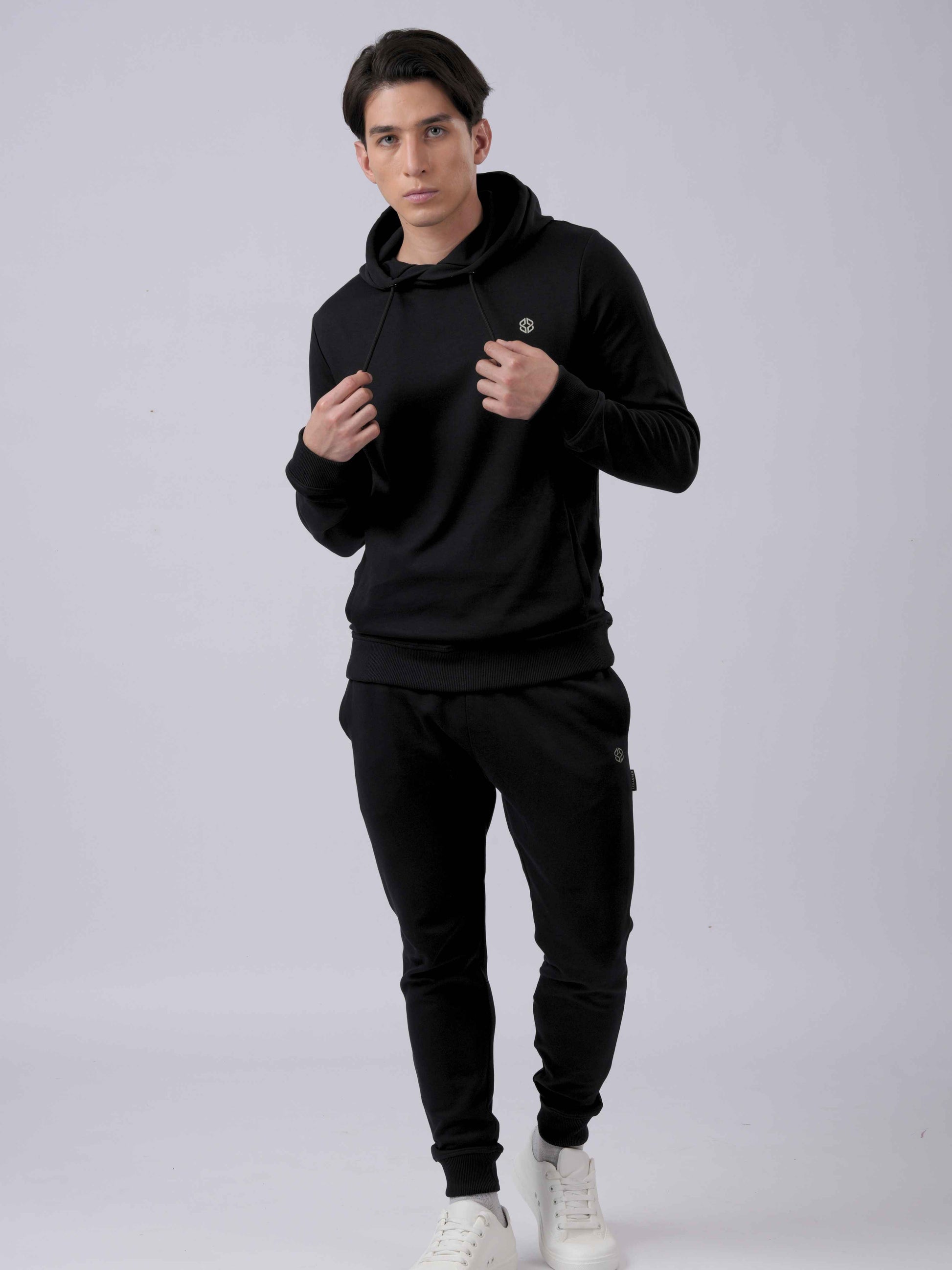 Model wearing LEXANBER men's slim fit black hoodie and jogger with golden logo - Lexanber UK