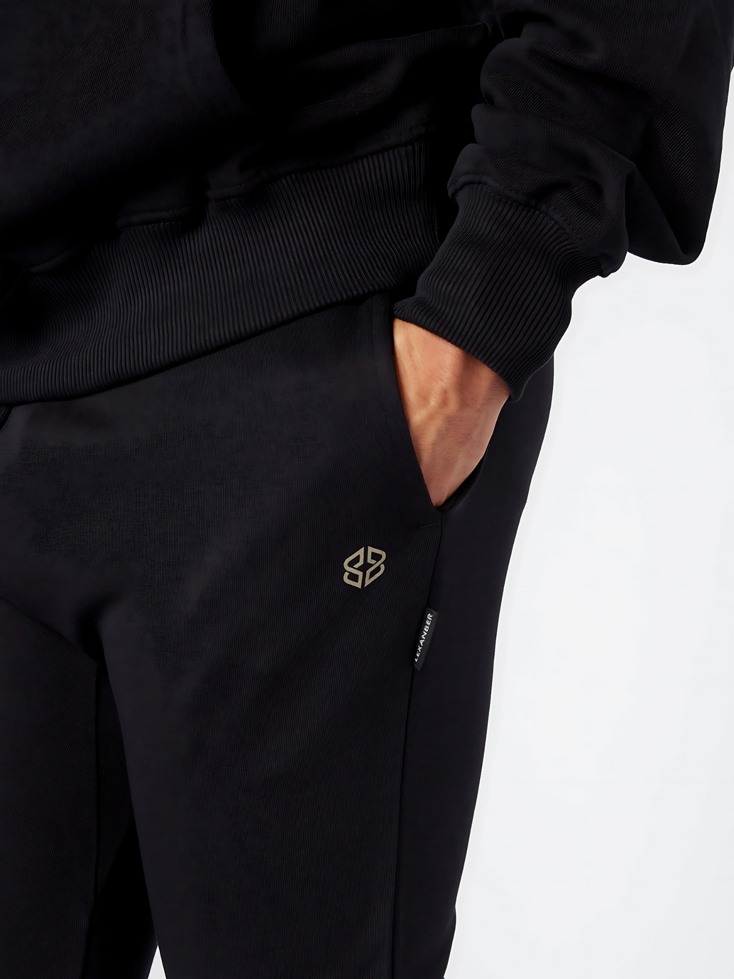 Close-up view of men's slim fit daily wear black jogger with golden logo - Lexanber UK