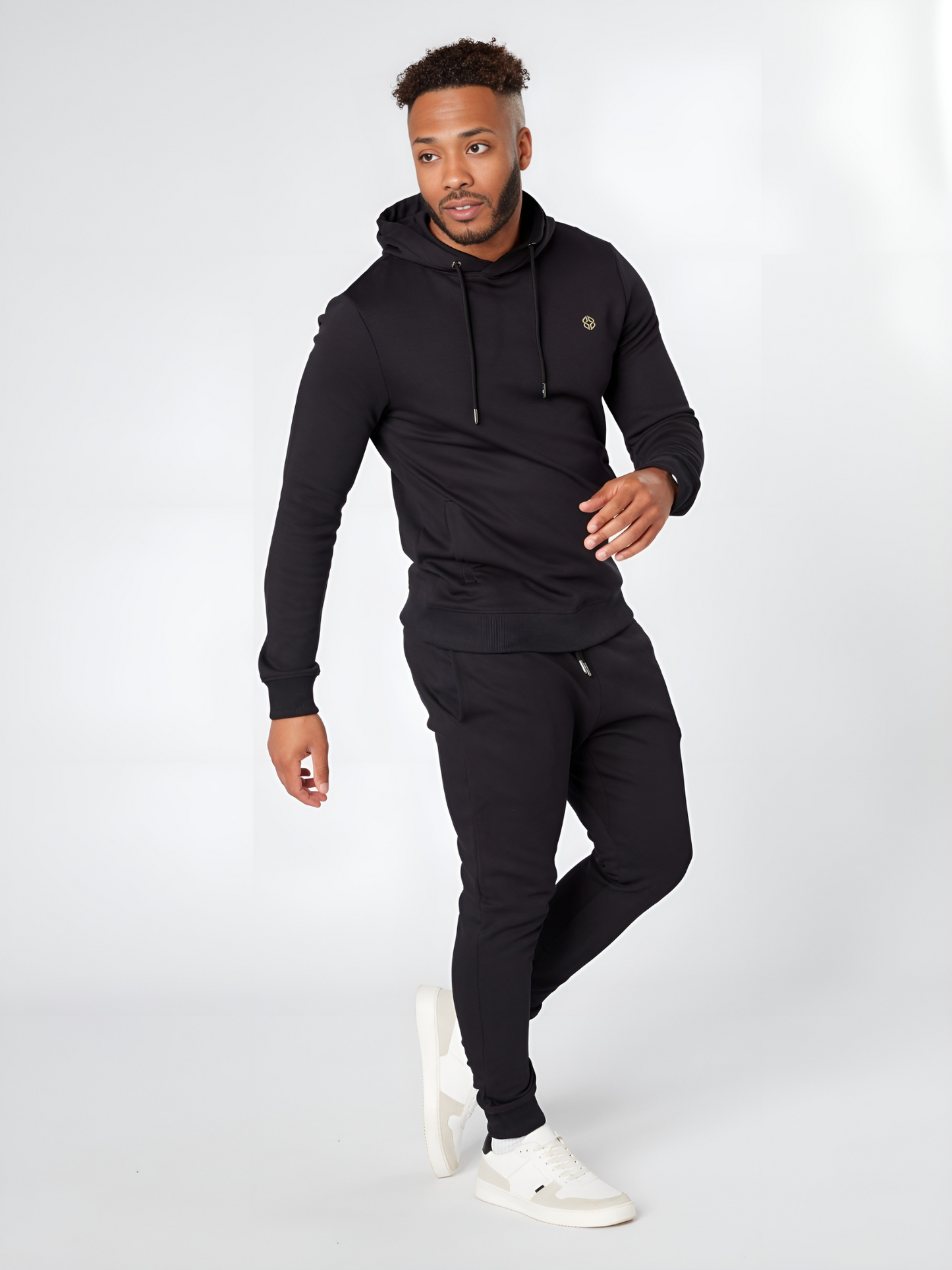 Model wearing LEXANBER men's slim fit black hoodie and jogger with golden logo - Lexanber UK